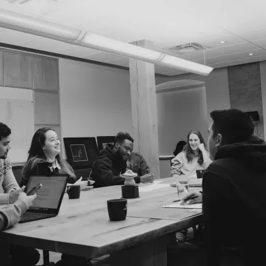 people sitting around a table talking